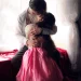 Two adults sharing a quiet intimate moment by a window